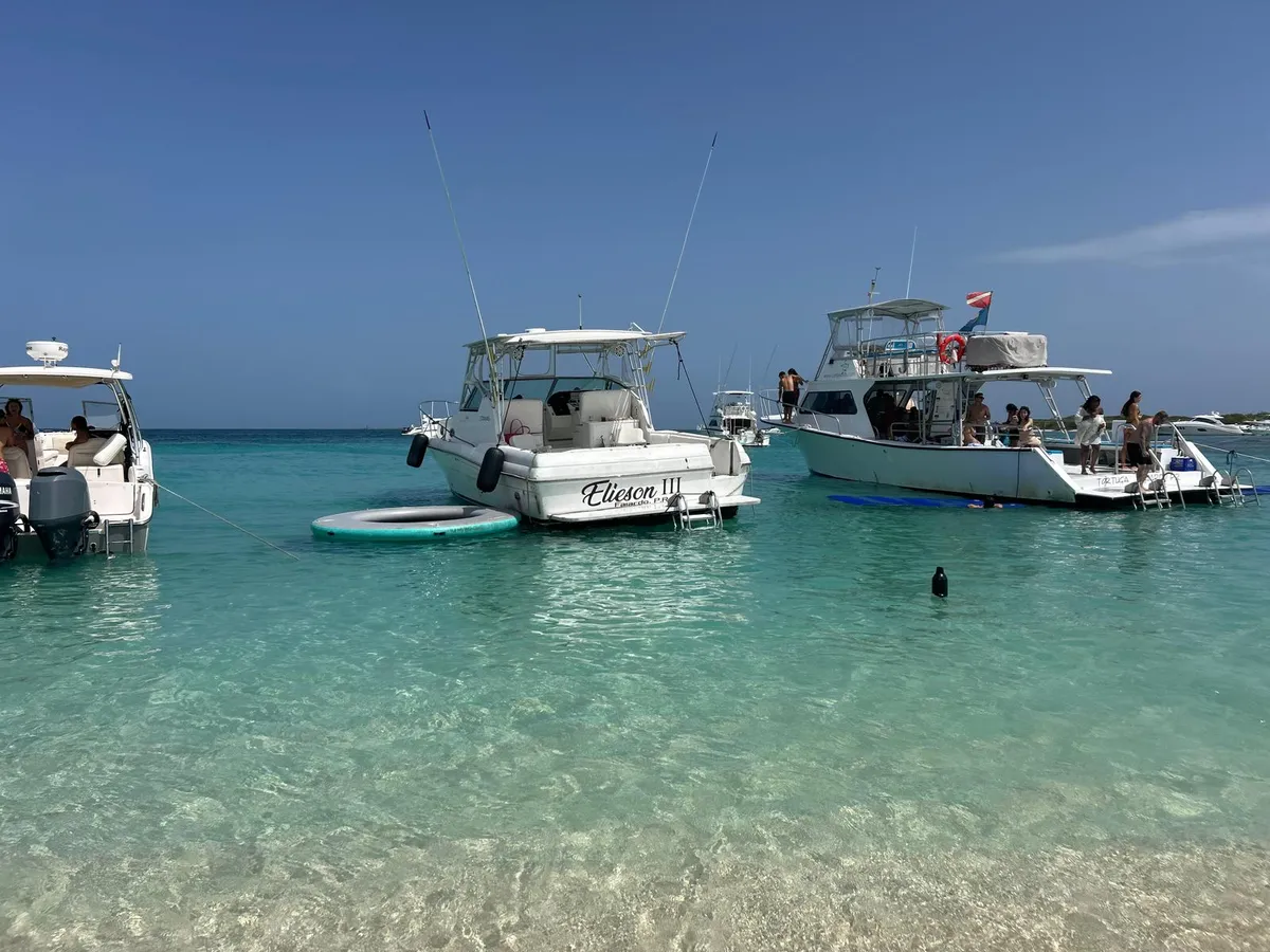 El Stamas 40' fondeado en agua turquesa frente a la playa, en un día despejado